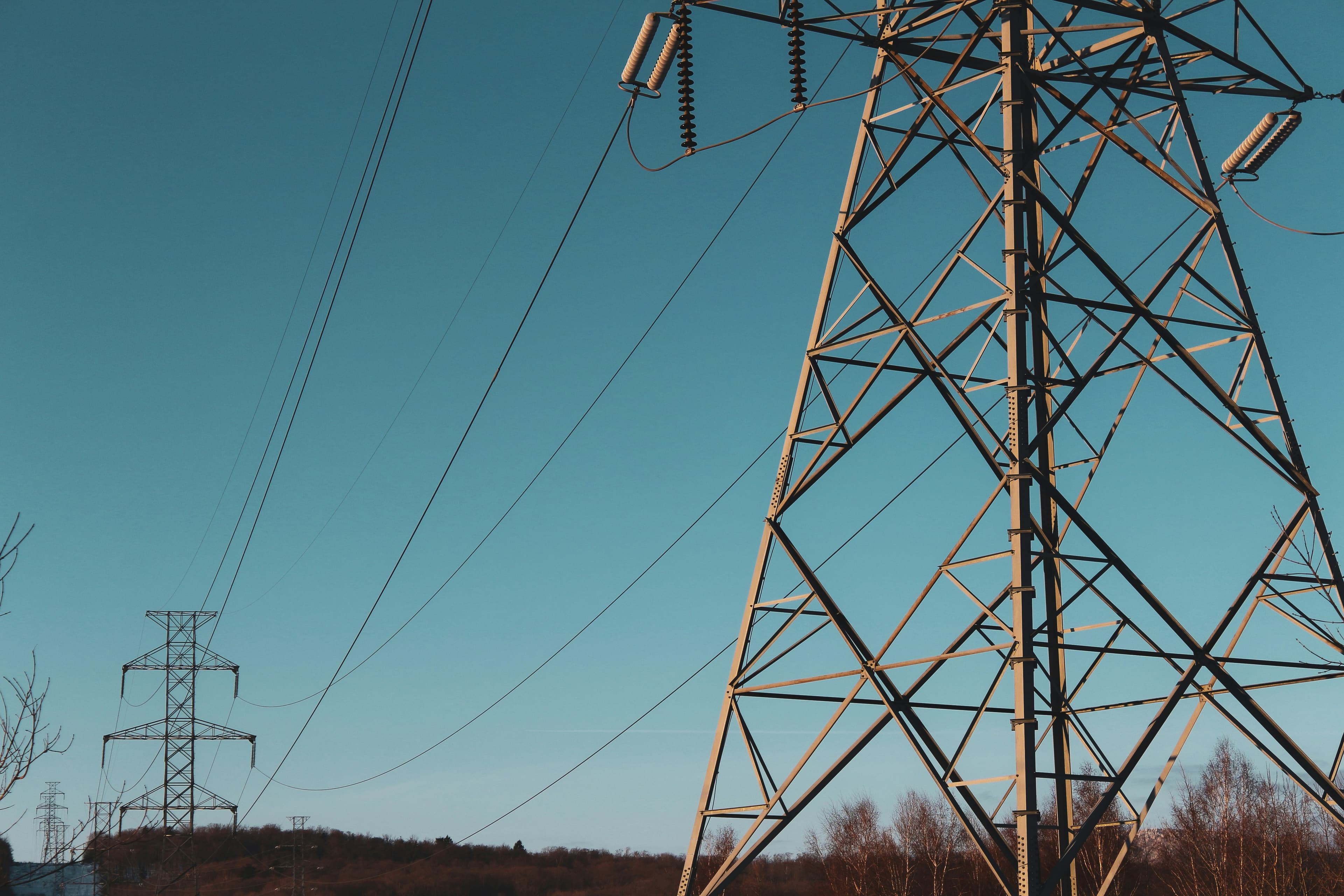 Electrical transmission towers and power lines infrastructure representing European energy system coordination