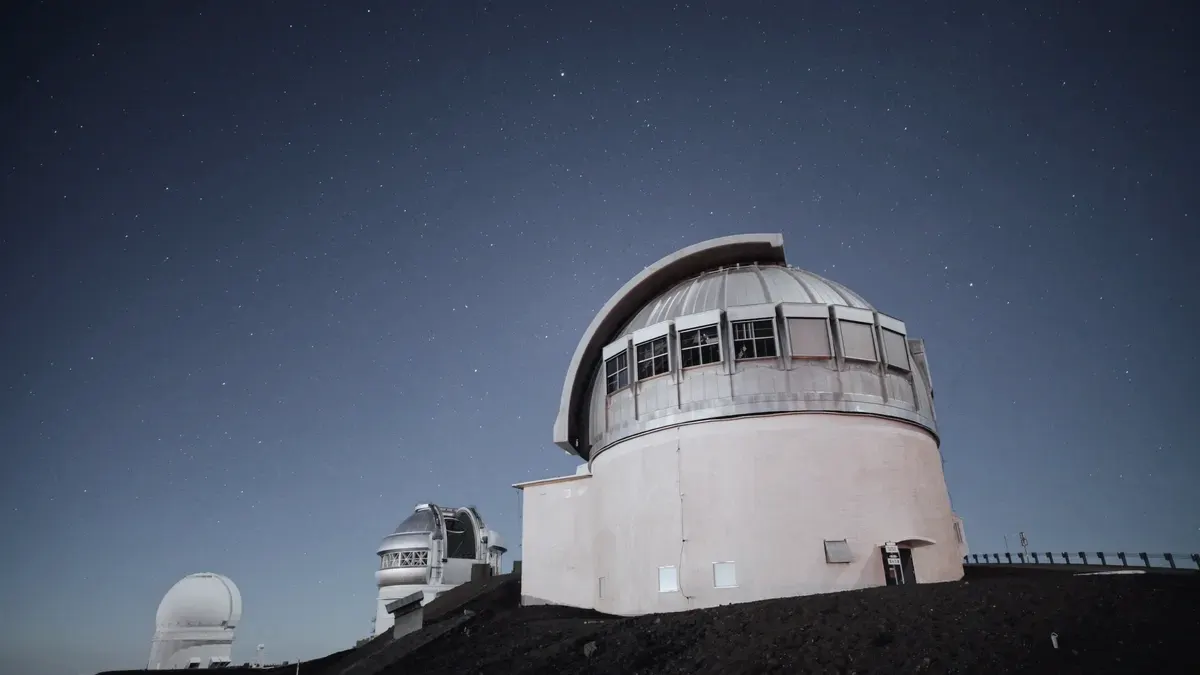 An observatory dome under a clear night sky